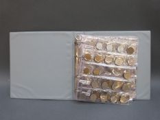 A folder containing an amateur collection of world coinage,