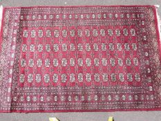 A red ground bokhara rug,