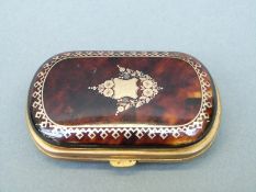 A tortoiseshell purse inlaid with gold piquot design,