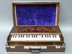 Indian portable harmonium or baja, in integral case, with 25 pearloid keys,