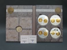 The History of Britain coinage comprising four large silver plated with spot gold decoration,