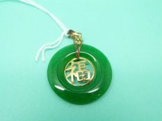 A jadeite pendant in the form of a disc with 18ct gold mount and Chinese characters to the centre