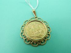 A 1911 gold full sovereign in 9ct gold mount, weight 10.