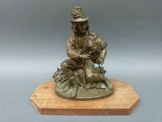 A 19th Century bronze of a labourer at harvest time sitting on a wheat sheaf with bagpipes,