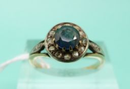 A Victorian 18ct gold ring set with a round cut sapphire surrounded by rose cut diamonds (Size O)