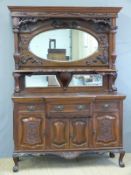 A late 19thC/early 20thC breakfront sideboard with bevelled triple mirror back,