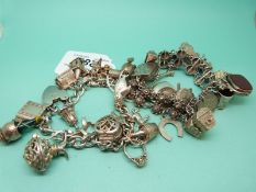 A silver charm bracelet and a white metal bracelet with hallmarked and white metal charms (144g)
