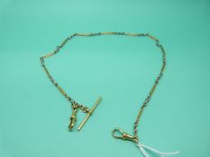 A bi-coloured 18ct gold watch chain made up of alternating white gold knots and yellow gold