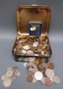 A tin of various world and UK coinage, some silver including George III and IV shillings,