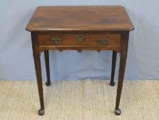 A Georgian mahogany lowboy with single drawer and shaped front frieze, raised on pad feet,