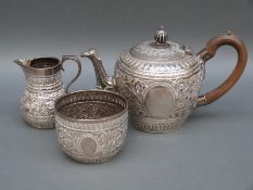 A Victorian Goldsmiths and Silversmiths Company hallmarked silver bachelors tea set in the Indian
