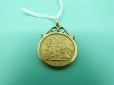An 1913 gold half sovereign in a 9ct gold clip mount,