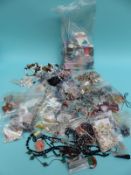 A large quantity of loose beads and necklaces including jet, coral, agate, pearls, clasps,