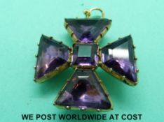 A Victorian Maltese cross pendant set with purple stones