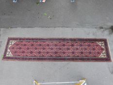A wool runner with red ground,
