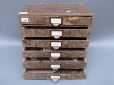 A vintage fibreboard coin collector's cabinet containing a collection of largely UK coinage,