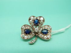A Victorian brooch set with three mixed cut sapphires,