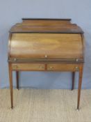 A late 19th/early 20thC cylinder bureau with slide out writing surface and two drawers below,