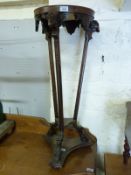 A 19thC carved mahogany jardiniere stand with ram's head and hoofed feet,