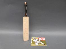 A miniature cricket bat signed by four England international players including Jack Russell