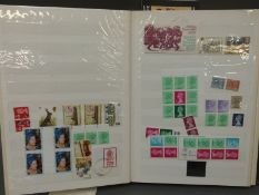 Three albums of St Kitts stamps and a stockbook of mint stamps including GB