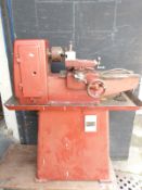 A model engineer's or similar lathe with three and four jaw chucks, tailstock etc, length 94cm,