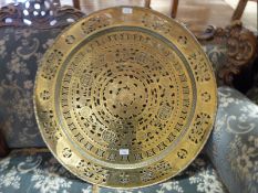 An Eastern pierced brass table top,