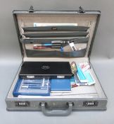A briefcase containing various draughtman's equipment