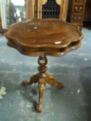 An inlaid table on tripod base,