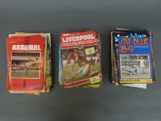 A collection of football programmes including Manchester United, Arsenal and Liverpool,