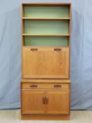 A retro G plan bookcase with fall flap bureau door,