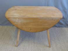 A retro Ercol light elm table (H71 x L112 x D122cm)