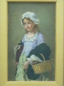 A 19th/20thC oil on canvas of a young girl holding a book and basket,