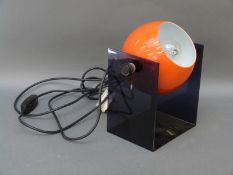 A retro orange globe lamp,