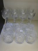 Fourteen Thomas Webb cut glass wine glasses and whisky tumblers.