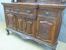 A late 19thC/early 20thC breakfront sideboard with bevelled triple mirror back,