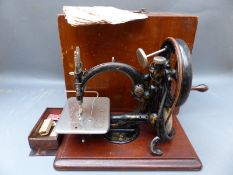 A Willcox and Gibbs chainstitch sewing machine with original wooden box,