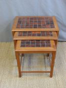 A retro nest of Danish tile inset hardwood tables (H47 x W58 x D42cm)