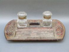 A boulle style inlaid rosewood and tortoiseshell desk stand with two inkwells
