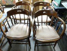 A set of four oak captain's chairs with upholstered seats