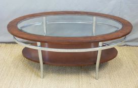 A retro mahogany and chrome glazed table raised on shaped legs with undershelf (H48 x L115 x W62cm)