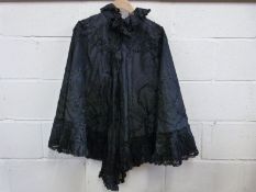 A late Victorian ladies mourning cape with pleated decoration to the sleeves