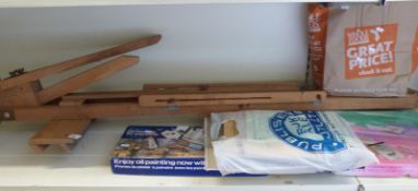 Two artist's easels and a large quantity of tinned powder paint,