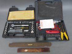 A vintage Rabone level another brass topped level and two sets of tools in cases