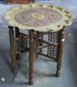 An Eastern brass topped folding table