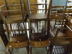 A set of six Arts and Crafts Art Nouveau oak chairs with slim split backs raised on cabriole legs
