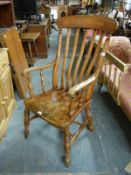 A high backed elm seated Windsor armchair