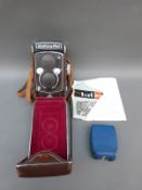 A cased Yashica-mat TLR camera,