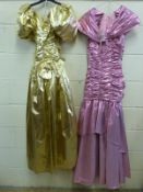 Two ball gowns by John Charles, size 10 gold in colour & size 12 pink in colour, both full length.