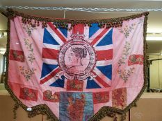 A Queen Victoria 1887 Jubilee celebration banner with embroidered flowers and tassel decoration on